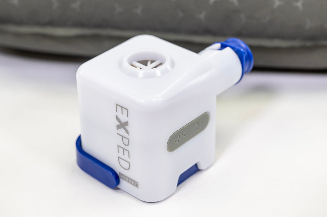 Exped Widget pump placed on a surface, designed for inflating outdoor gear.
