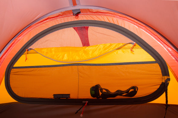 Inner door of the Polaris tent featuring a partially unzipped viewing window/vent and mesh pocket for small items such as headlamps